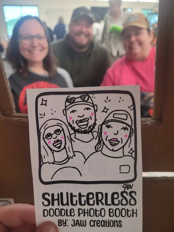 Trio holding up their group doodle portrait