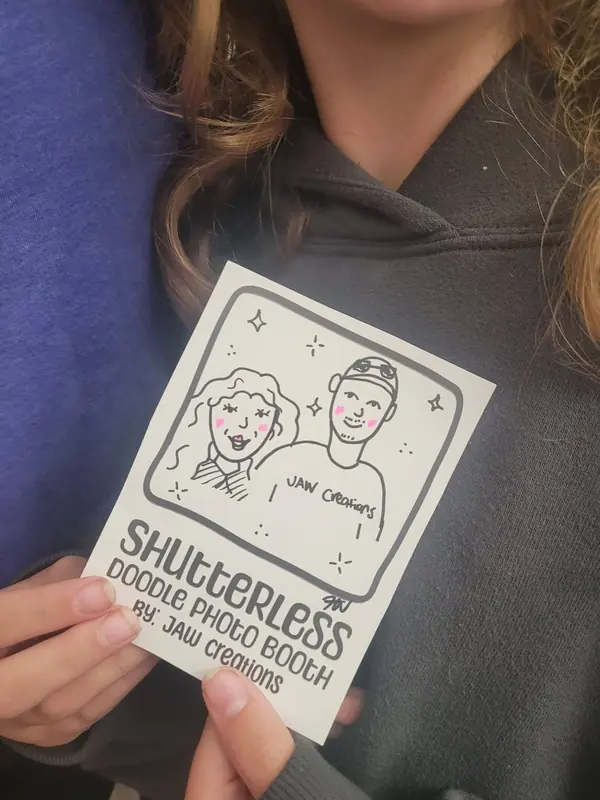 Guest holding a duo doodle portrait