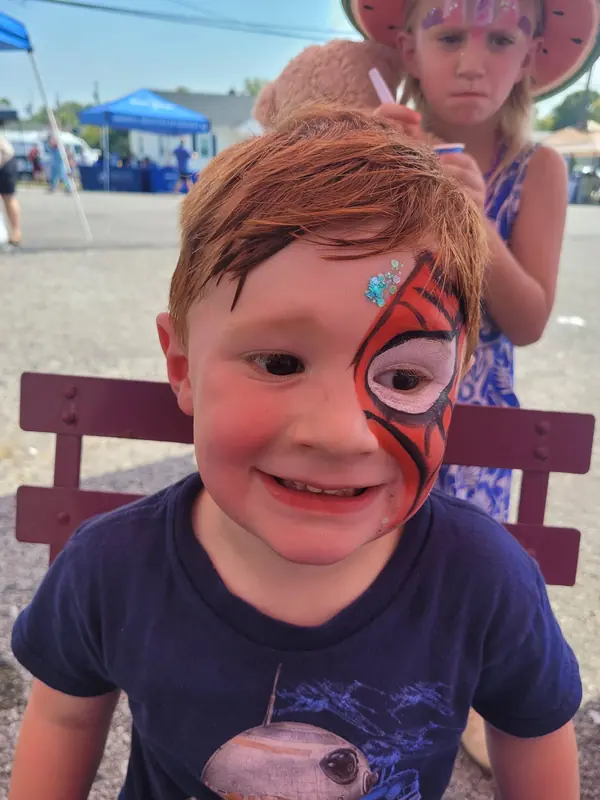 Child with a half-face spider hero design