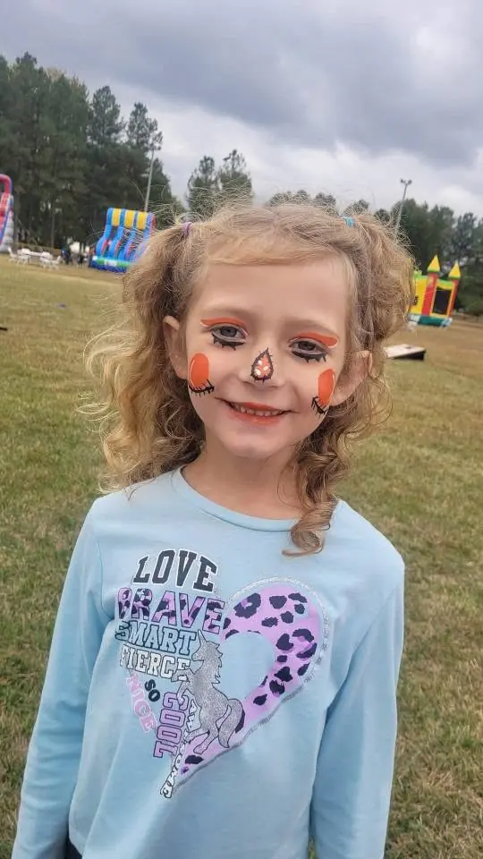 Child with a kitty nose and whiskers