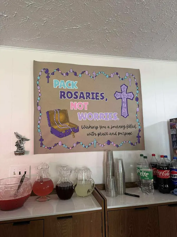 Pack Rosaries, Not Worries banner displayed at an event