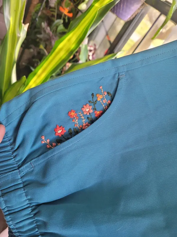 Blue sleeve embroidered with small wildflowers