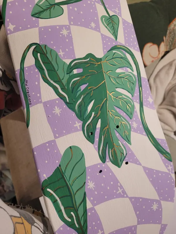 Purple checkerboard piece hand-painted with monstera leaves