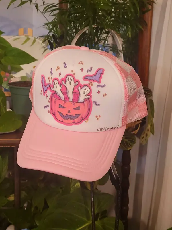 Pink trucker hat hand-painted with a jack-o'-lantern and ghosts