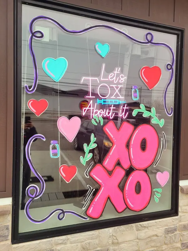 Window painted with Let's Tox About It, hearts and XOXO