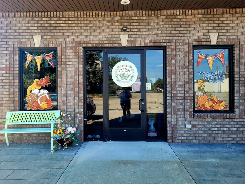Fall storefront windows with bunting and pumpkins